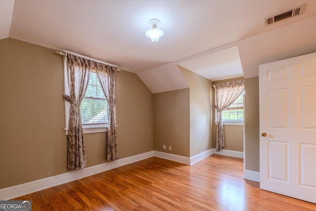 bonus room featuring vaulted ceiling and light wood-type flooring