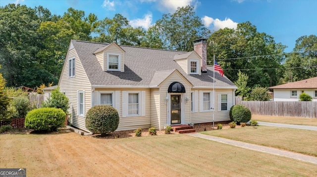 cape cod-style house with a front yard