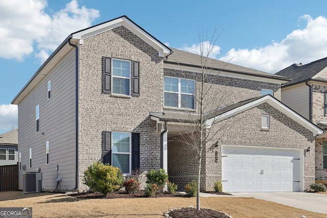 view of front of property with a garage and central air condition unit