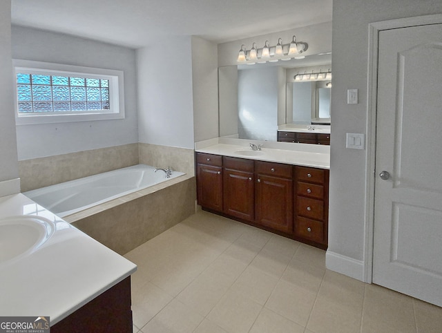 bathroom featuring vanity, tile patterned floors, and tiled bath