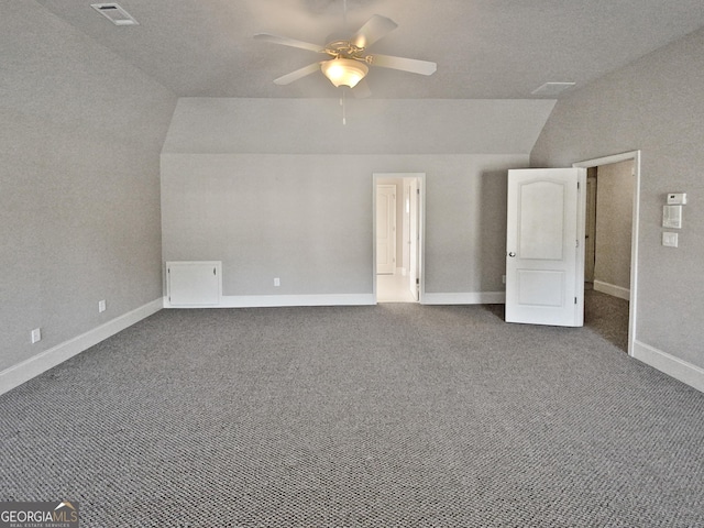 interior space featuring vaulted ceiling, ceiling fan, and carpet