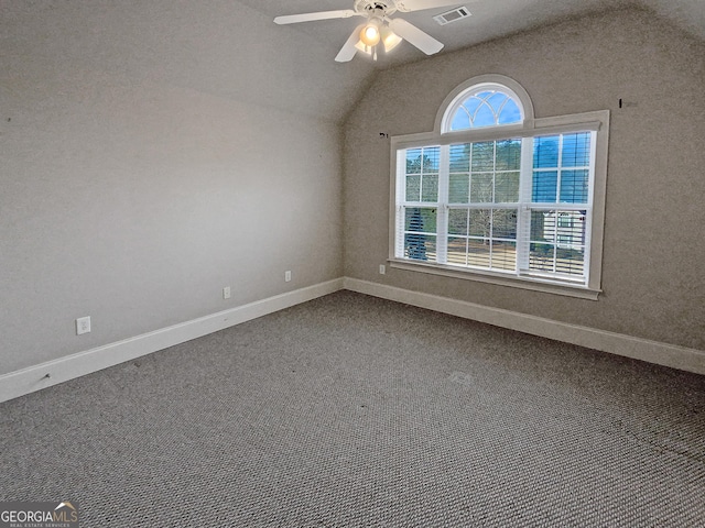 carpeted empty room featuring ceiling fan and lofted ceiling