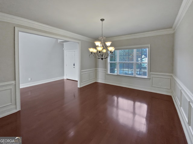 unfurnished dining area featuring an inviting chandelier, dark wood-type flooring, and ornamental molding