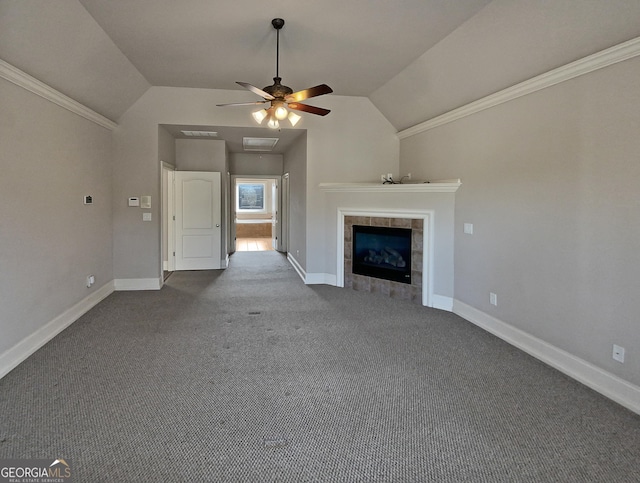 unfurnished living room featuring lofted ceiling, ceiling fan, carpet flooring, a fireplace, and ornamental molding