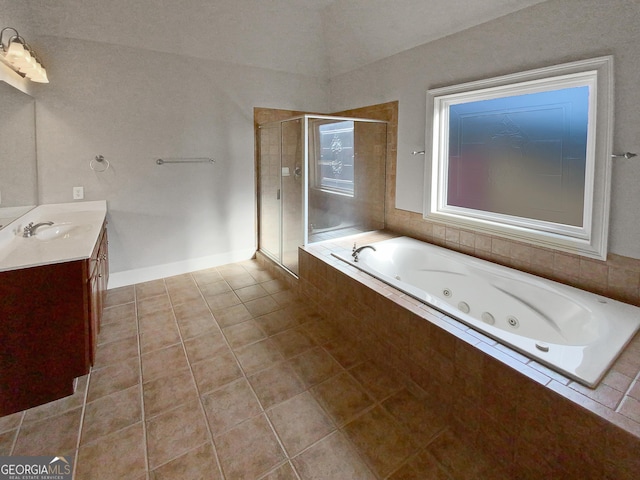 bathroom with vanity, tile patterned floors, and plus walk in shower