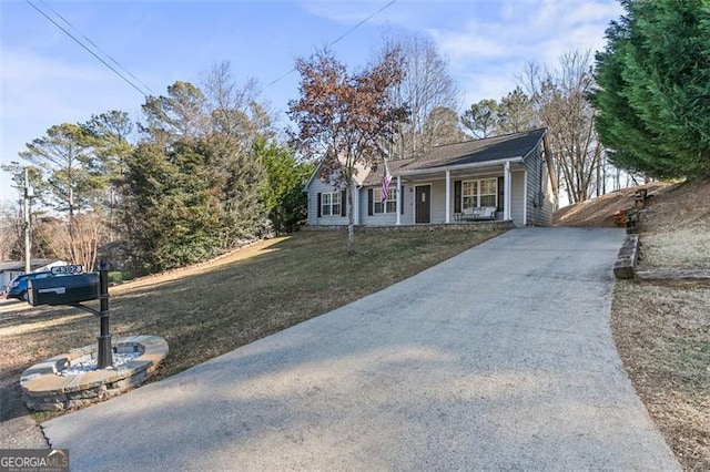 view of front of house with a porch and a front lawn