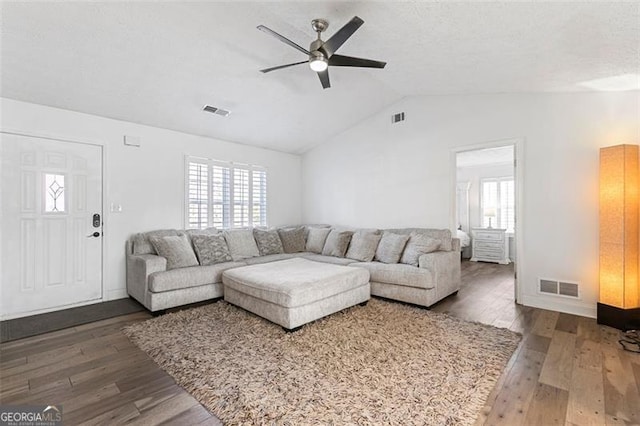 living room with ceiling fan, lofted ceiling, and dark hardwood / wood-style flooring