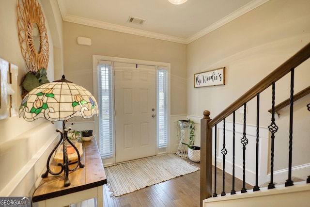 foyer entrance featuring crown molding and dark hardwood / wood-style floors