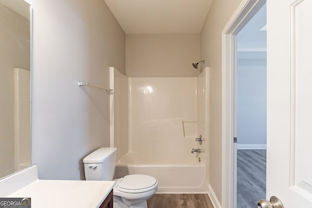 full bathroom featuring wood-type flooring, tub / shower combination, vanity, and toilet