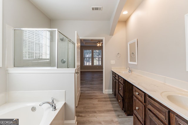 bathroom with vanity, hardwood / wood-style flooring, shower with separate bathtub, and ceiling fan