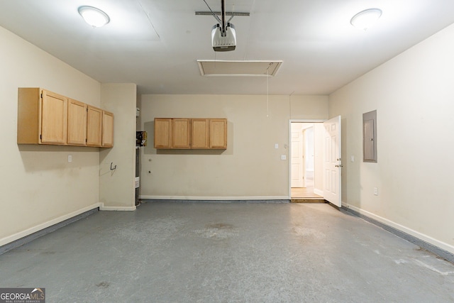 garage with a garage door opener and electric panel