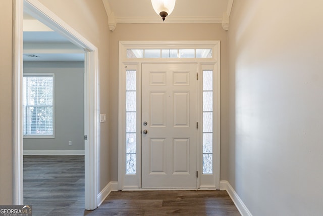 entryway featuring ornamental molding and dark hardwood / wood-style flooring