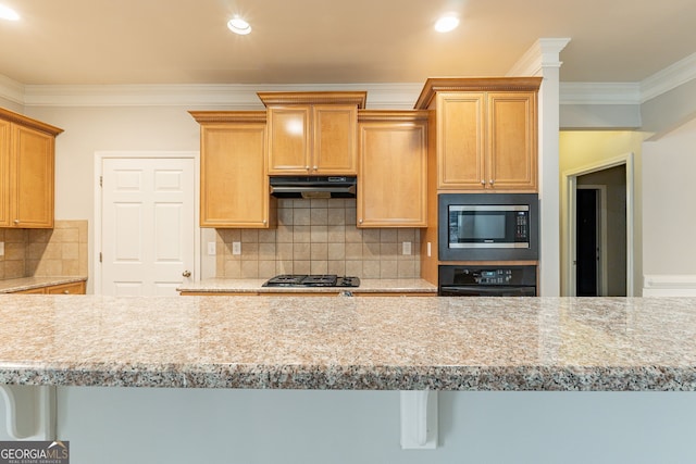 kitchen with stainless steel microwave, black oven, tasteful backsplash, ornamental molding, and gas stovetop