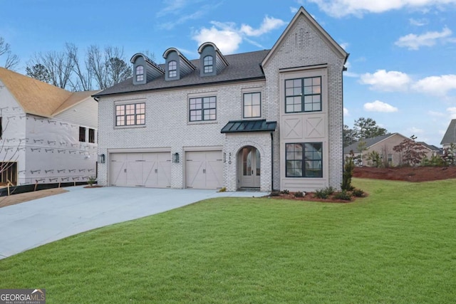 view of front of property featuring a garage and a front yard