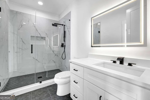 bathroom featuring vanity, tile patterned flooring, a shower with shower door, and toilet