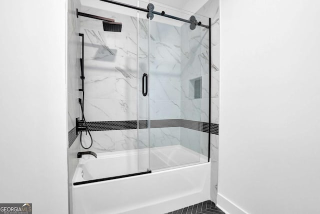 bathroom with tile patterned flooring and bath / shower combo with glass door