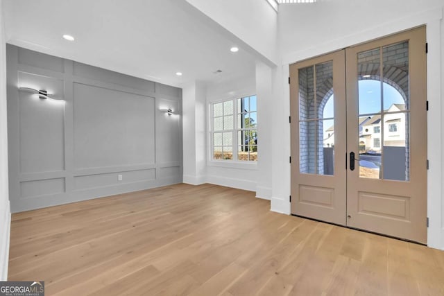 entrance foyer with light hardwood / wood-style flooring and french doors