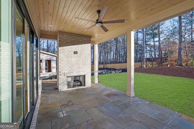 view of patio / terrace featuring an outdoor brick fireplace and ceiling fan