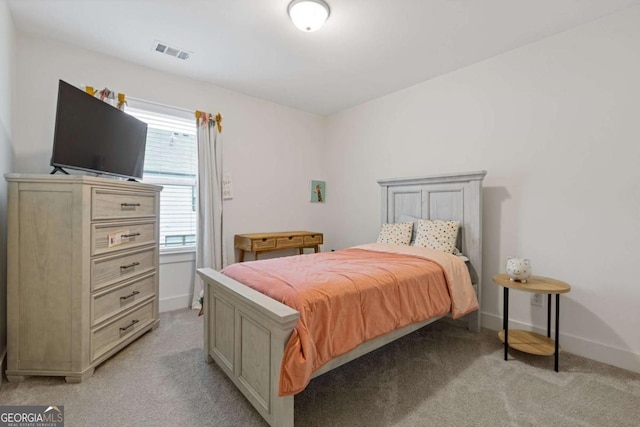 bedroom featuring light carpet