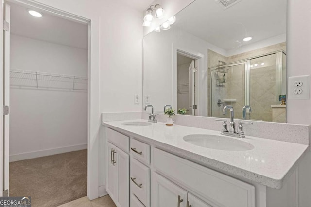 bathroom with tile patterned flooring, vanity, and a shower with shower door