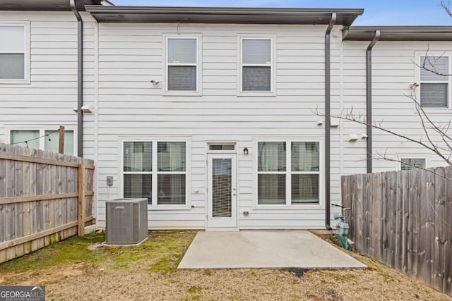 back of house featuring a patio area, central air condition unit, and a lawn