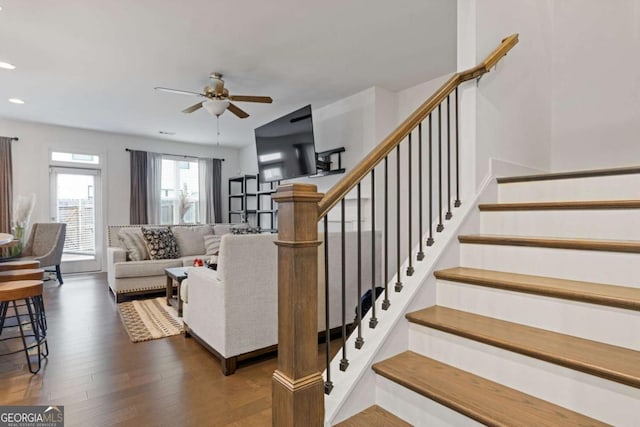 living room with dark wood-type flooring and ceiling fan