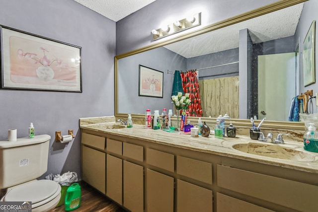 bathroom featuring hardwood / wood-style floors, vanity, a textured ceiling, curtained shower, and toilet