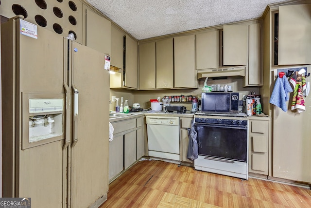 kitchen featuring a textured ceiling, white appliances, and light hardwood / wood-style flooring