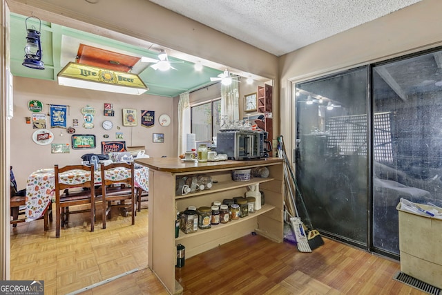 kitchen featuring parquet floors and a textured ceiling