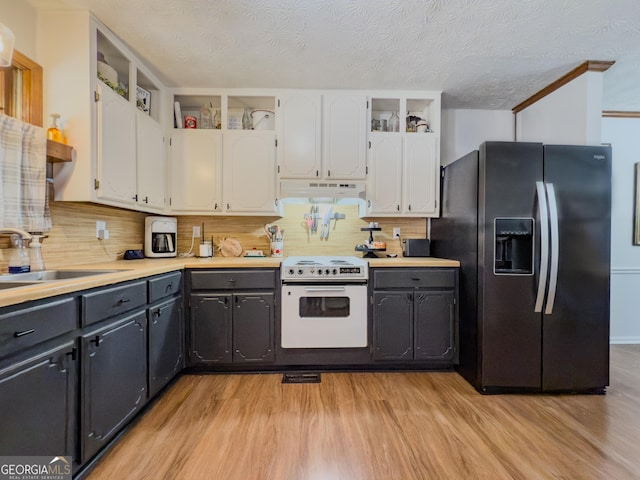 kitchen featuring sink, white cabinetry, stainless steel fridge with ice dispenser, a textured ceiling, and electric range