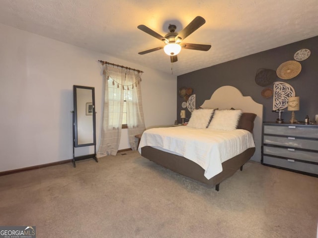 bedroom with a textured ceiling, ceiling fan, and carpet flooring