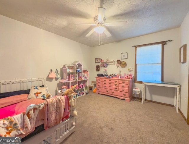 carpeted bedroom featuring ceiling fan and a textured ceiling