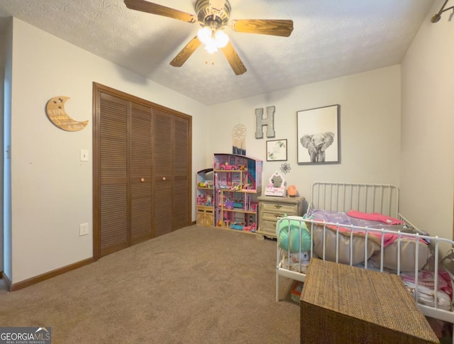 bedroom with a textured ceiling, a closet, ceiling fan, and carpet flooring