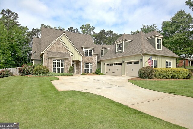 45 Misty Creek Cv, Newnan, GA 30265 - view of front of house with board and batten siding, a front lawn, driveway, and roof with shingles
