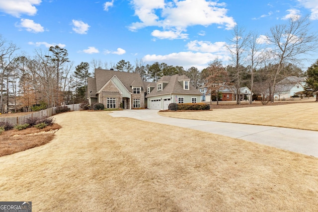 view of front of house featuring a garage and a front lawn