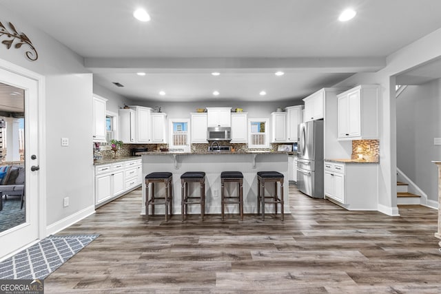 45 Misty Creek Cv, Newnan, GA 30265 - kitchen featuring stainless steel appliances, a sink, light wood-type flooring, white cabinets, and recessed lighting