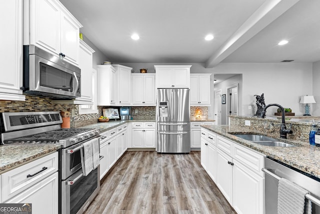 45 Misty Creek Cv, Newnan, GA 30265 - bedroom with multiple windows, baseboards, wood finished floors, high vaulted ceiling, and ceiling fan