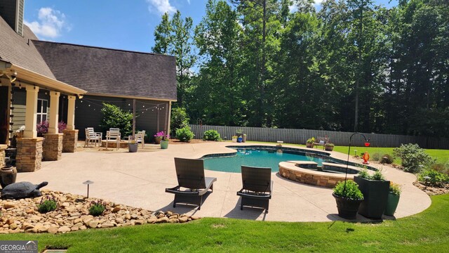 45 Misty Creek Cv, Newnan, GA 30265 - view of front of house with a front lawn, stone siding, driveway, an attached garage, and a shingled roof