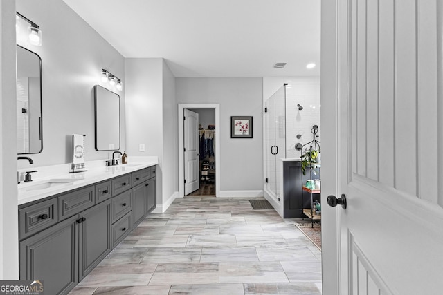 45 Misty Creek Cv, Newnan, GA 30265 - bathroom with tiled shower, baseboards, double vanity, and wood finished floors