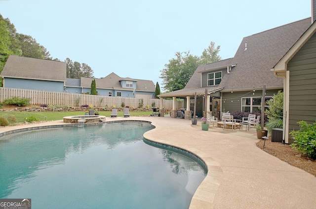 45 Misty Creek Cv, Newnan, GA 30265 - pool at twilight featuring a patio and a pool with connected hot tub