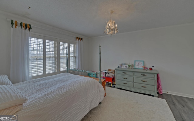 bedroom featuring crown molding, a textured ceiling, a notable chandelier, and light wood-type flooring