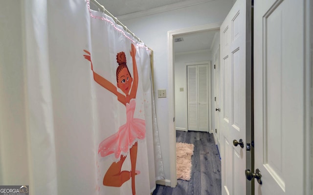 bathroom featuring hardwood / wood-style floors and crown molding