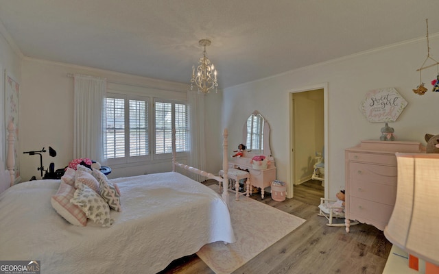 bedroom featuring hardwood / wood-style floors, crown molding, and a notable chandelier