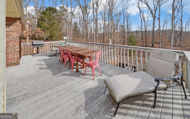 wooden deck featuring a grill