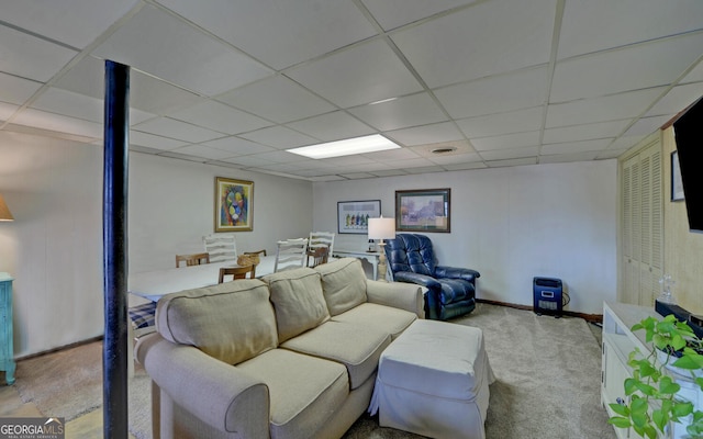 carpeted living room featuring a paneled ceiling