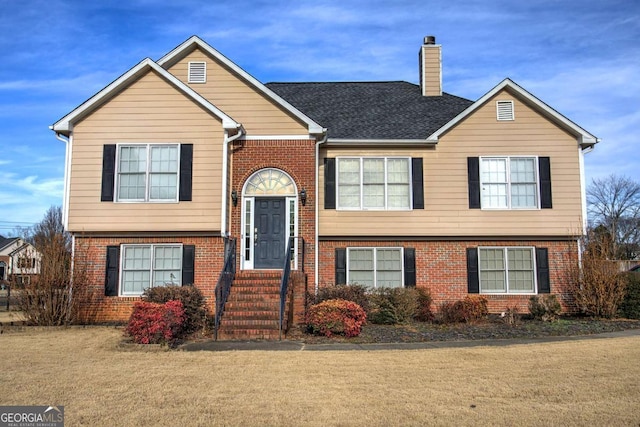 raised ranch with a front lawn