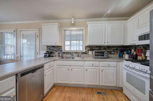 kitchen with white cabinetry and white appliances