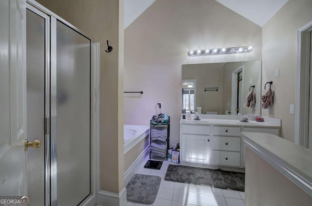 bathroom with tile patterned flooring, vaulted ceiling, independent shower and bath, and vanity