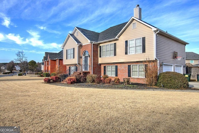 view of front facade with a garage and a front lawn