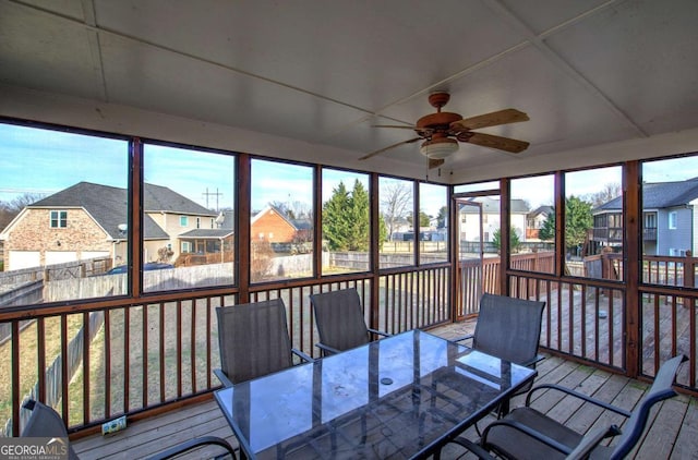 sunroom / solarium featuring ceiling fan